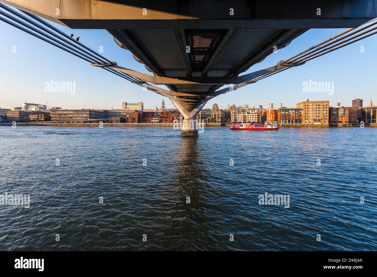 View of the River Thames from under the Millennium Bridge, South Bank, London, England, UK. Stock Photo