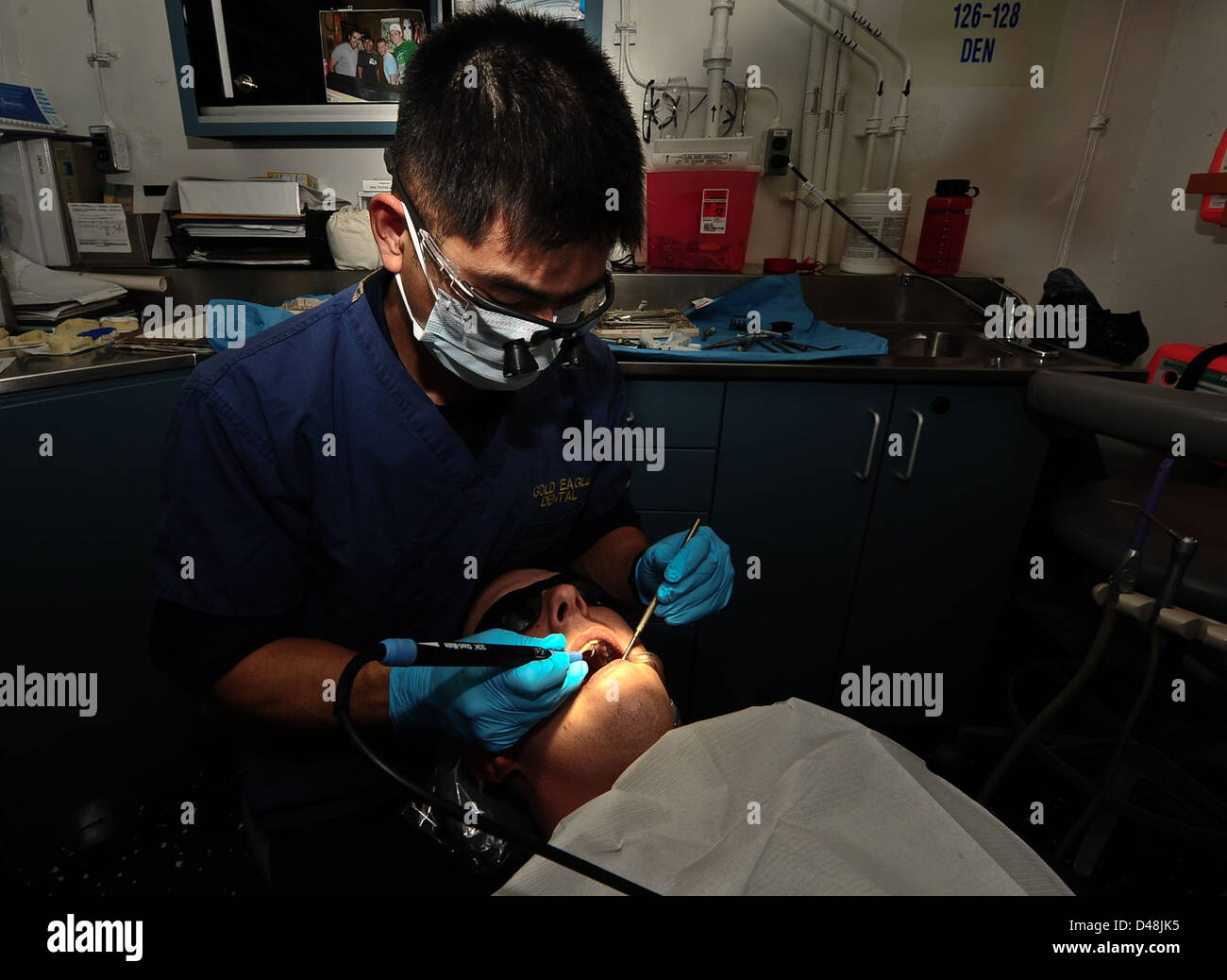 A dentist cleans teeth aboard USS Carl Vinson. Stock Photo
