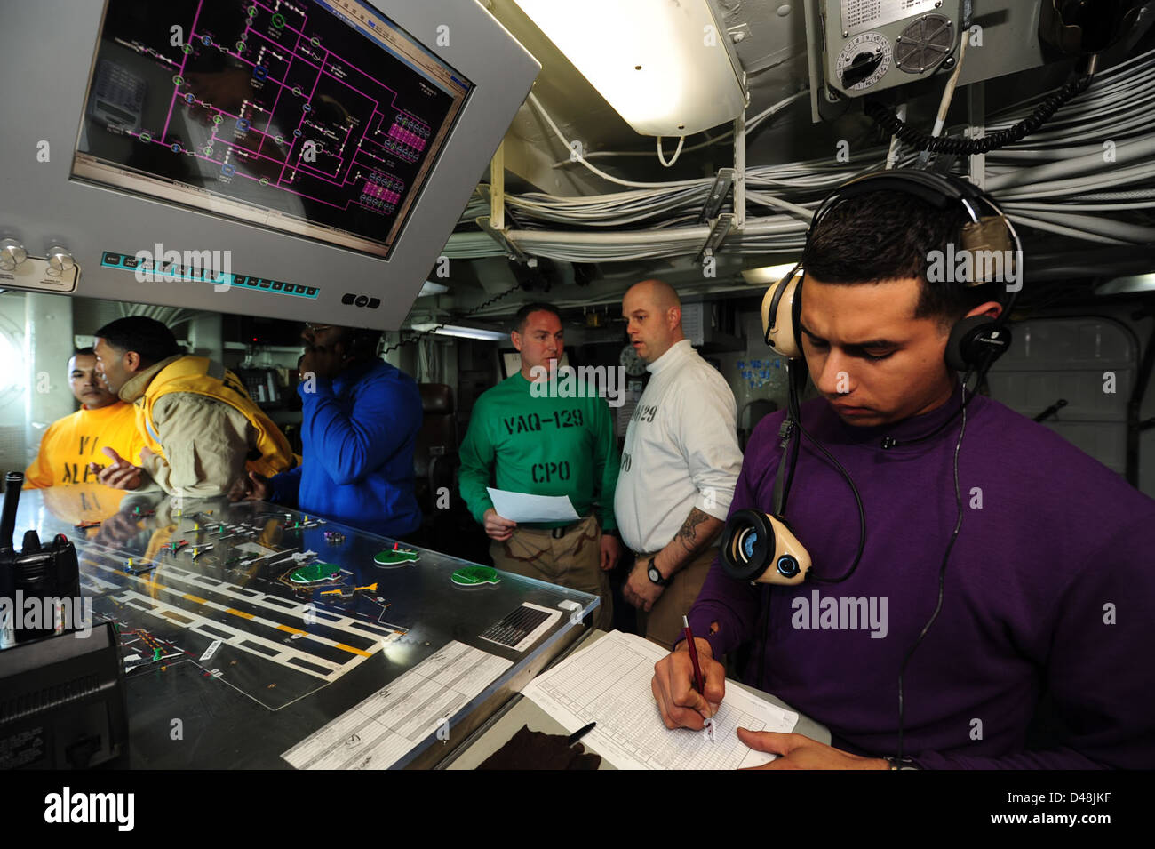 Sailors manage the flight deck aboard USS Carl Vinson. Stock Photo