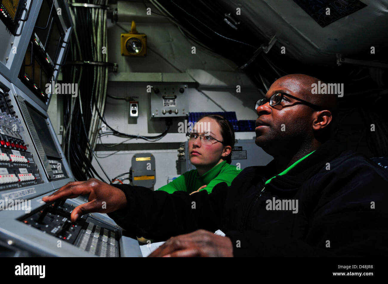 Sailors operate the ILARTS system aboard USS Carl Vinson. Stock Photo