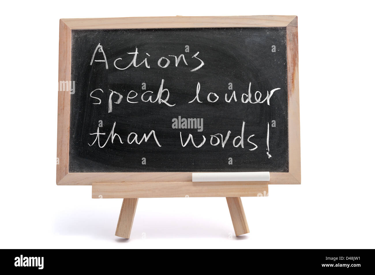 'Actions speak louder than words' saying written on blackboard over white background Stock Photo