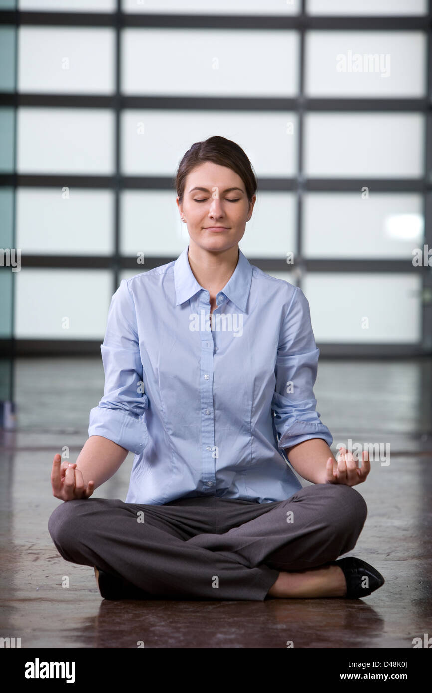 Business woman yoga at a modern office Stock Photo - Alamy