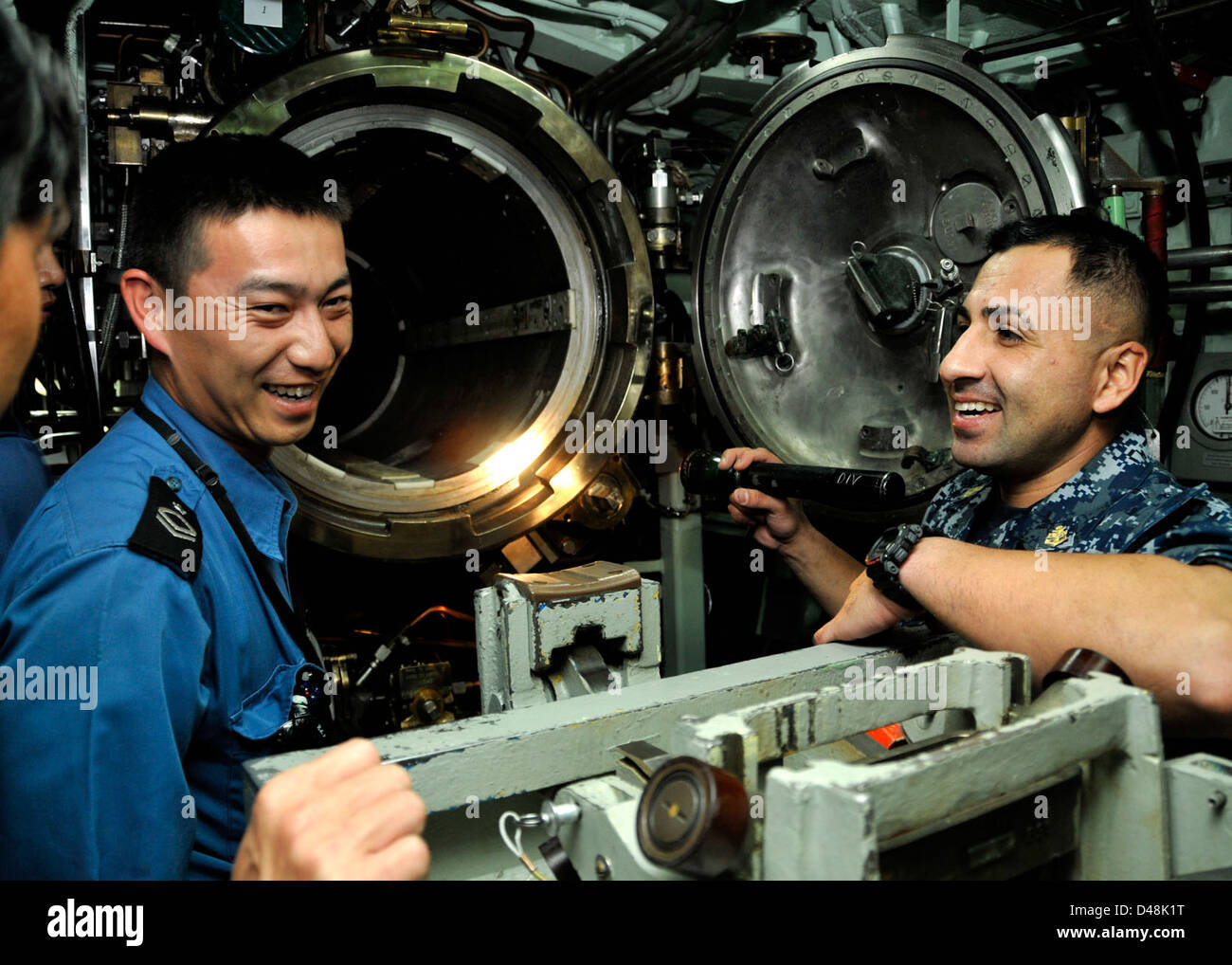 USS Greeneville hosts Japanese sailors. Stock Photo