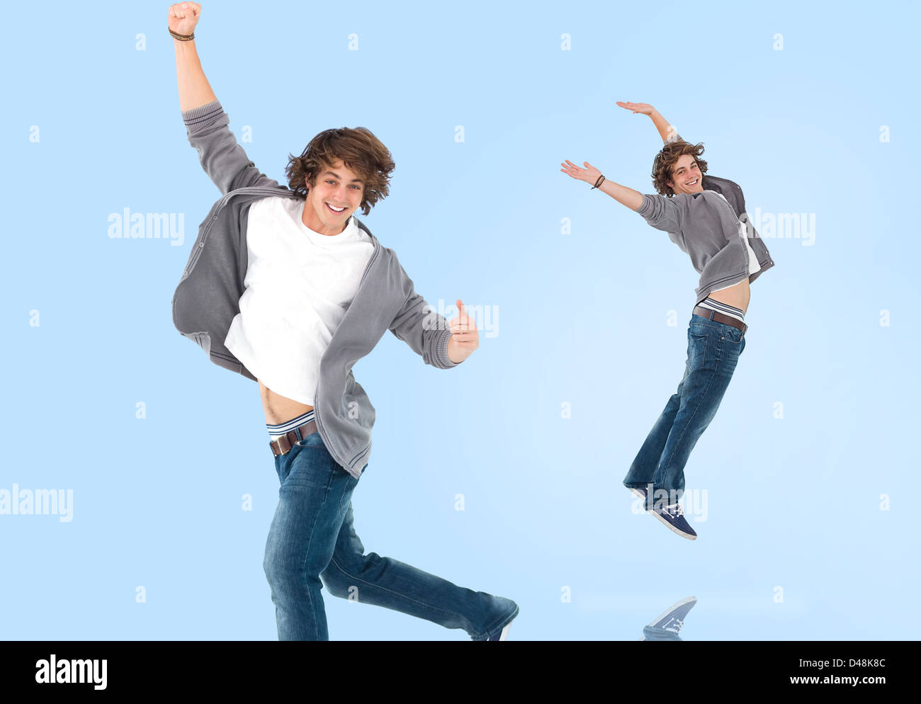 Two of the same teenage boy jumping for joy Stock Photo