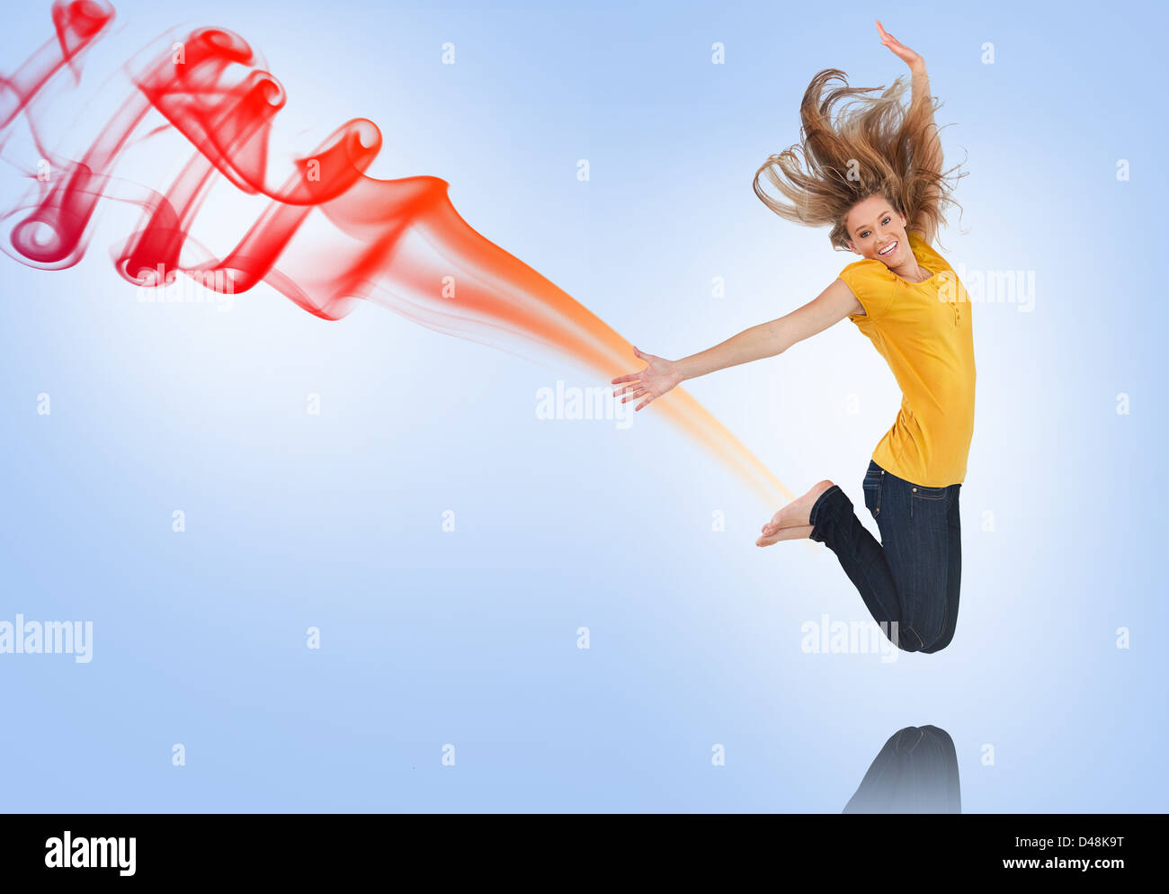 Pretty young woman jumping for joy with smoke trail Stock Photo