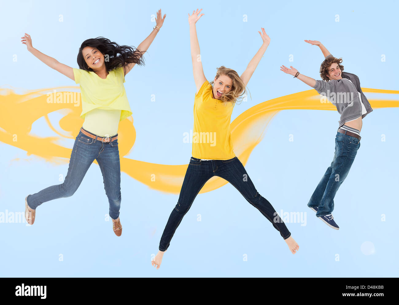 Attractive young man and women jumping for joy Stock Photo