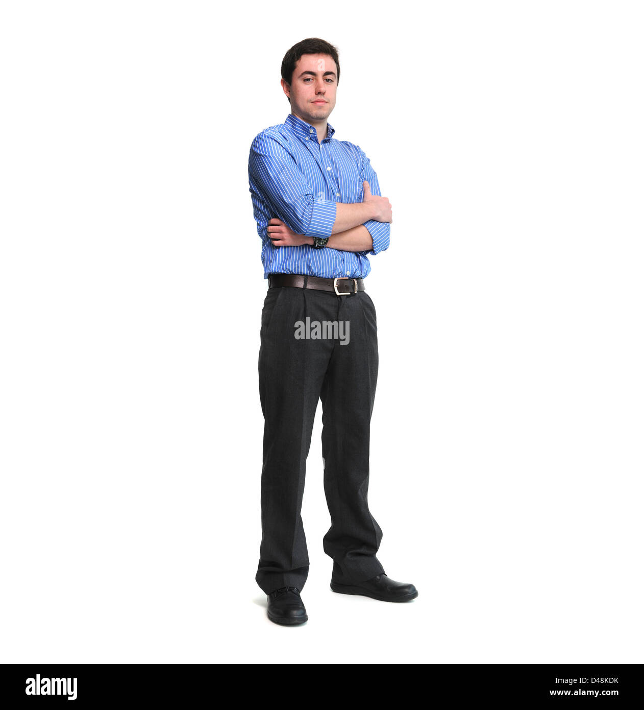 Full length portrait of young man with arms crossed isolated on white background Stock Photo