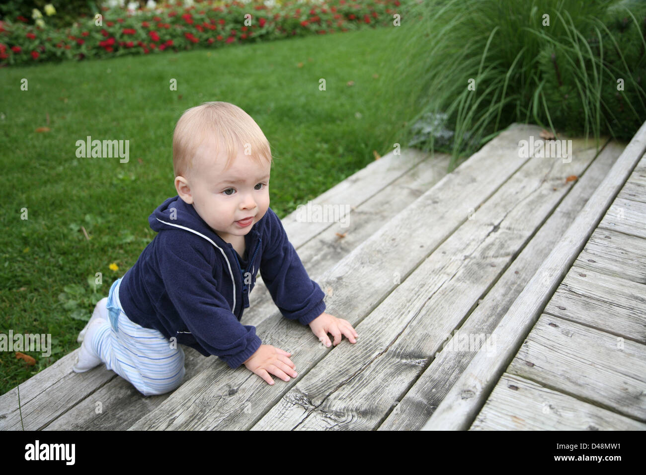 Toddler climbing stairs outside Stock Photo