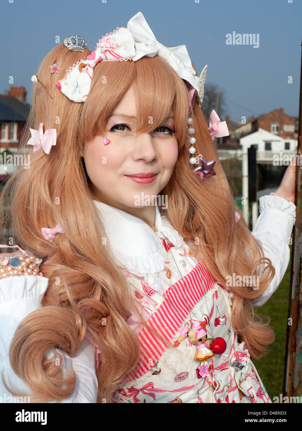 Female model in Cosplay Lolita Clothes outdoors near canal Stock Photo