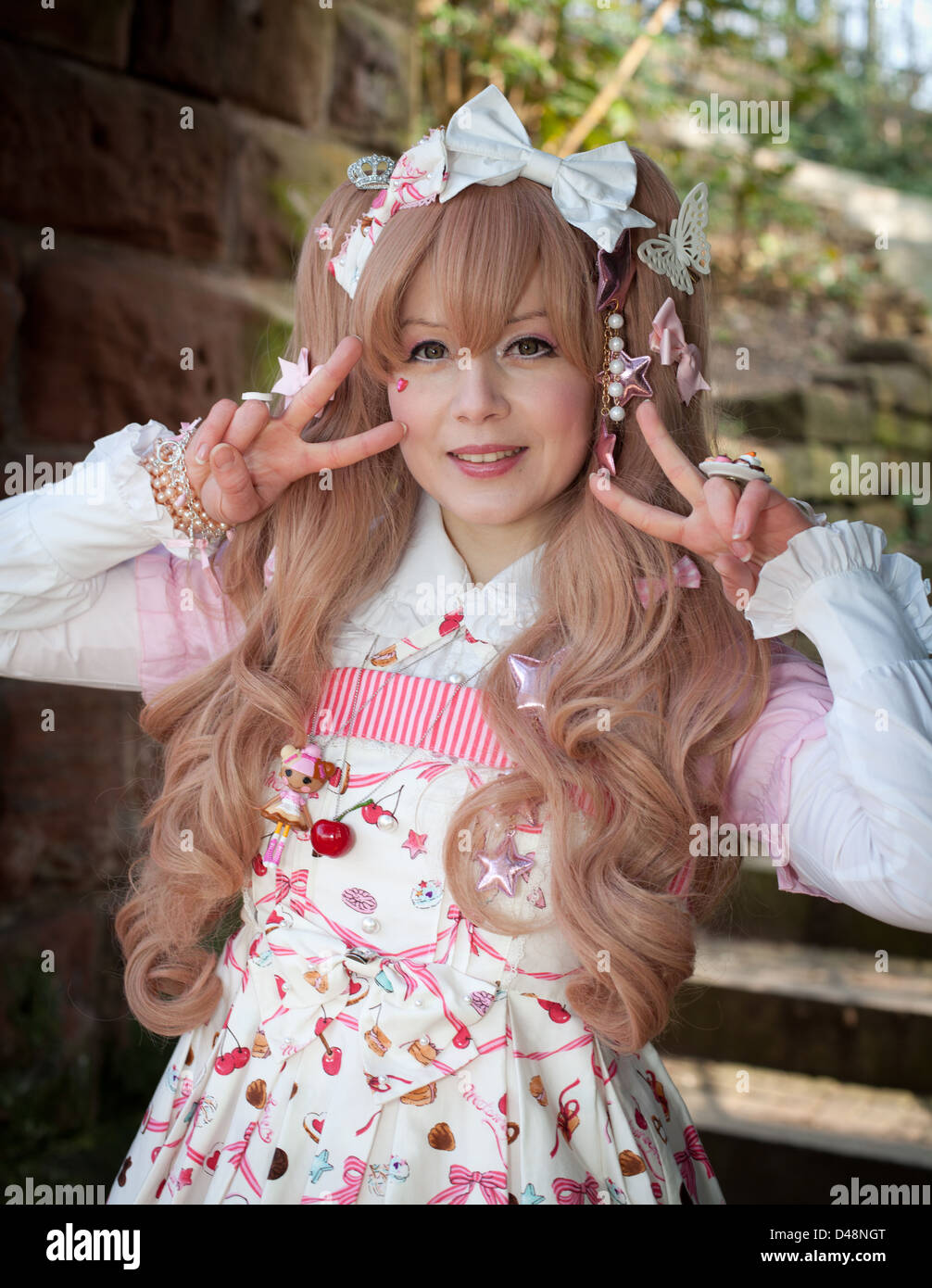 Female model in Cosplay Lolita Clothes outdoors near steps Stock Photo