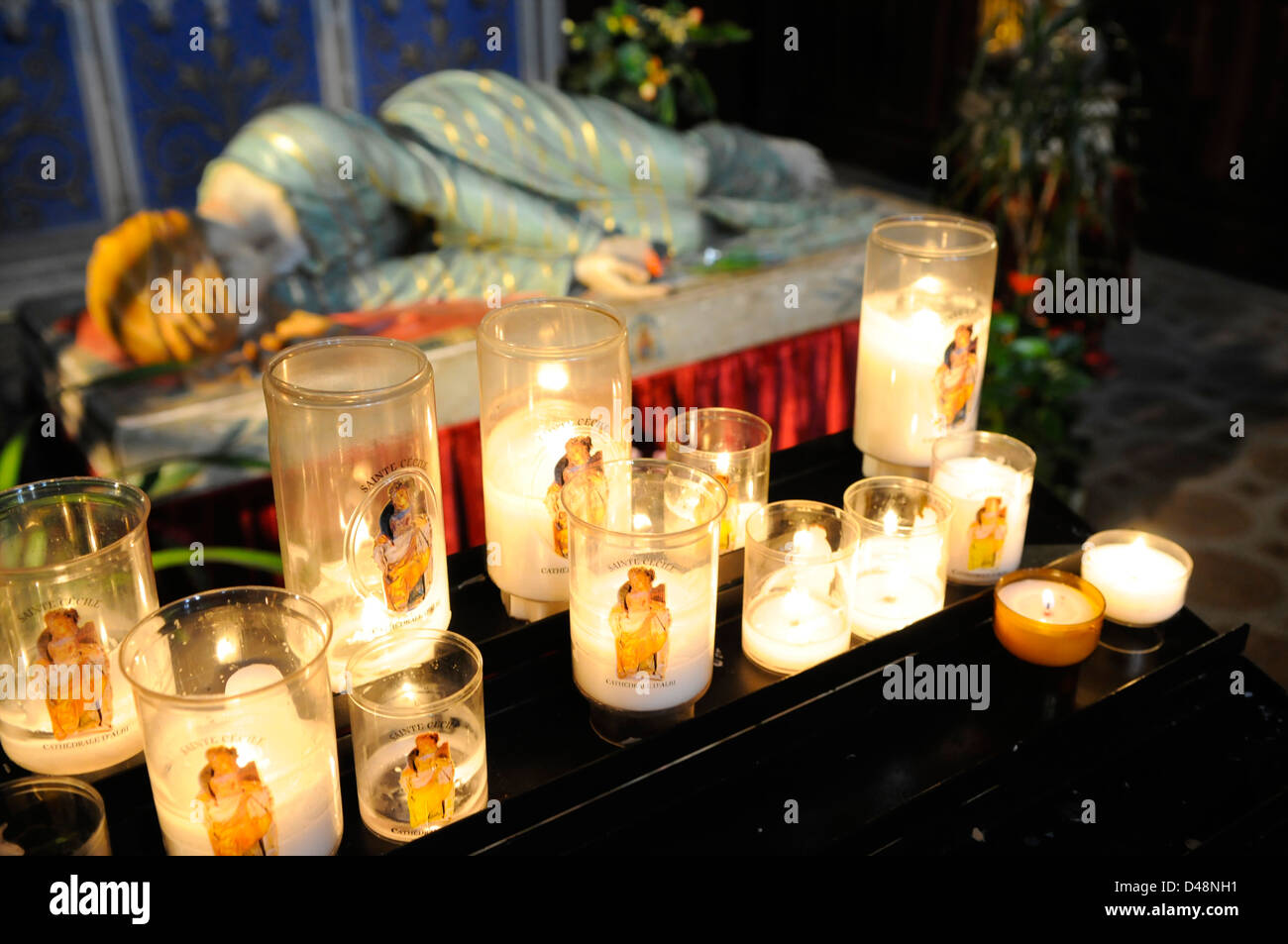Candles beside the effigy of St Cecile in the Catholic Cathedral. Albi, Tarn, France Stock Photo