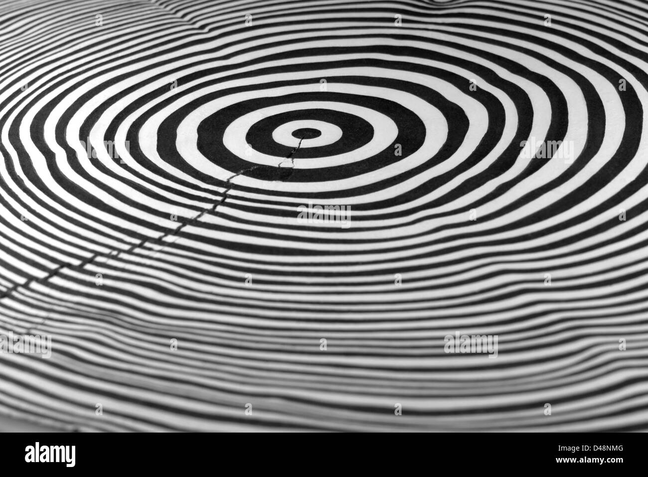 full frame abstract picture showing a piece of wood with black and white painted annual rings Stock Photo