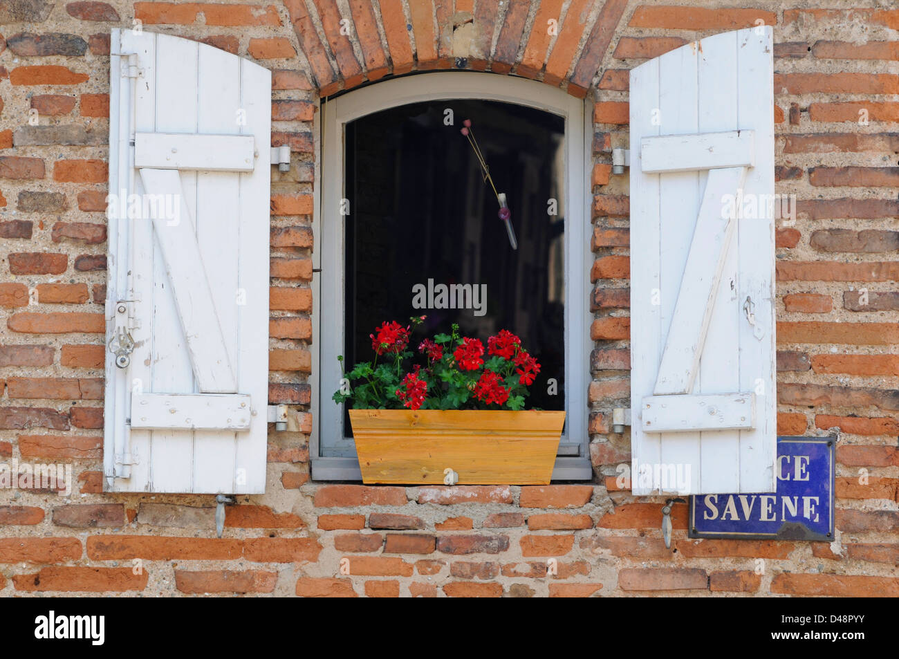 Old white shutters on a red brick building, typical of the vernacular style. Albi, Tarn, France Stock Photo