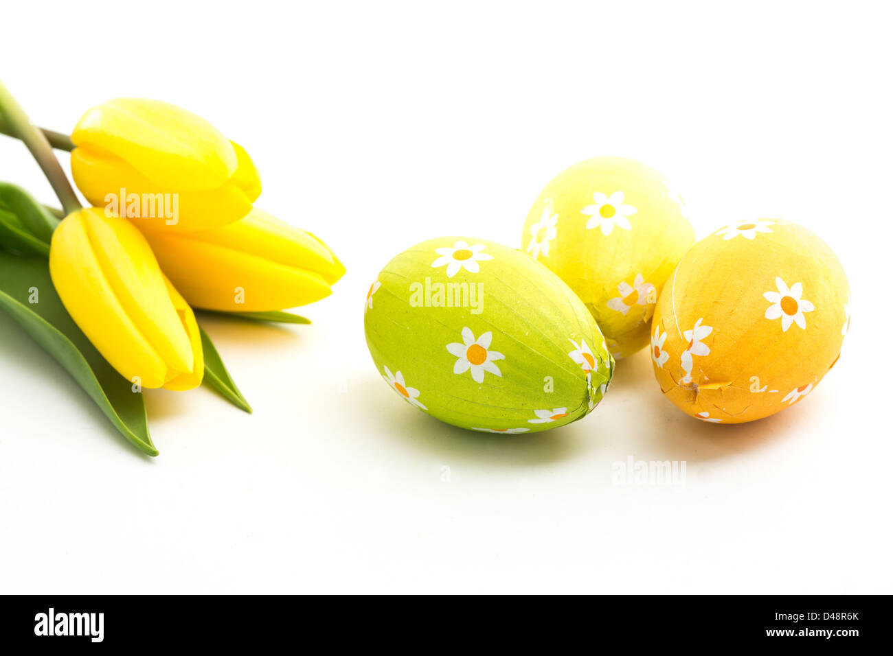 Three easter eggs with yellow tulips Stock Photo - Alamy