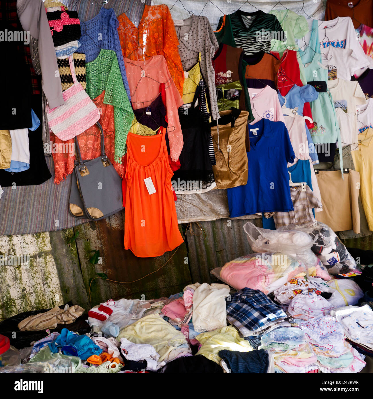 Man selling clothes street market hi-res stock photography and