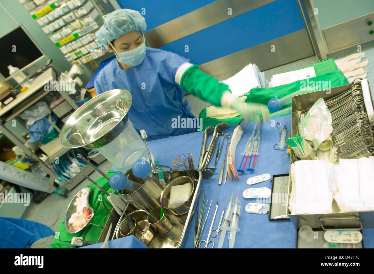 A surgeon prepares instruments and equipment for surgery. Stock Photo