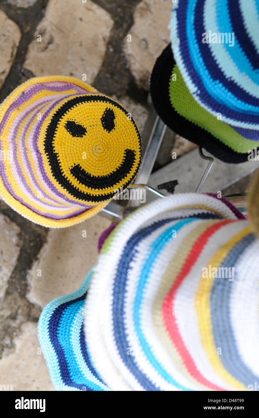 Market stall holders selling children's hats. Saint-Antonin-Noble-Val, Tarn et Garonne, France Stock Photo