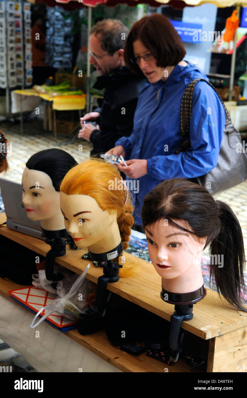 Market stall holders selling ladies wigs. Saint-Antonin-Noble-Val, Tarn et Garonne, France Stock Photo