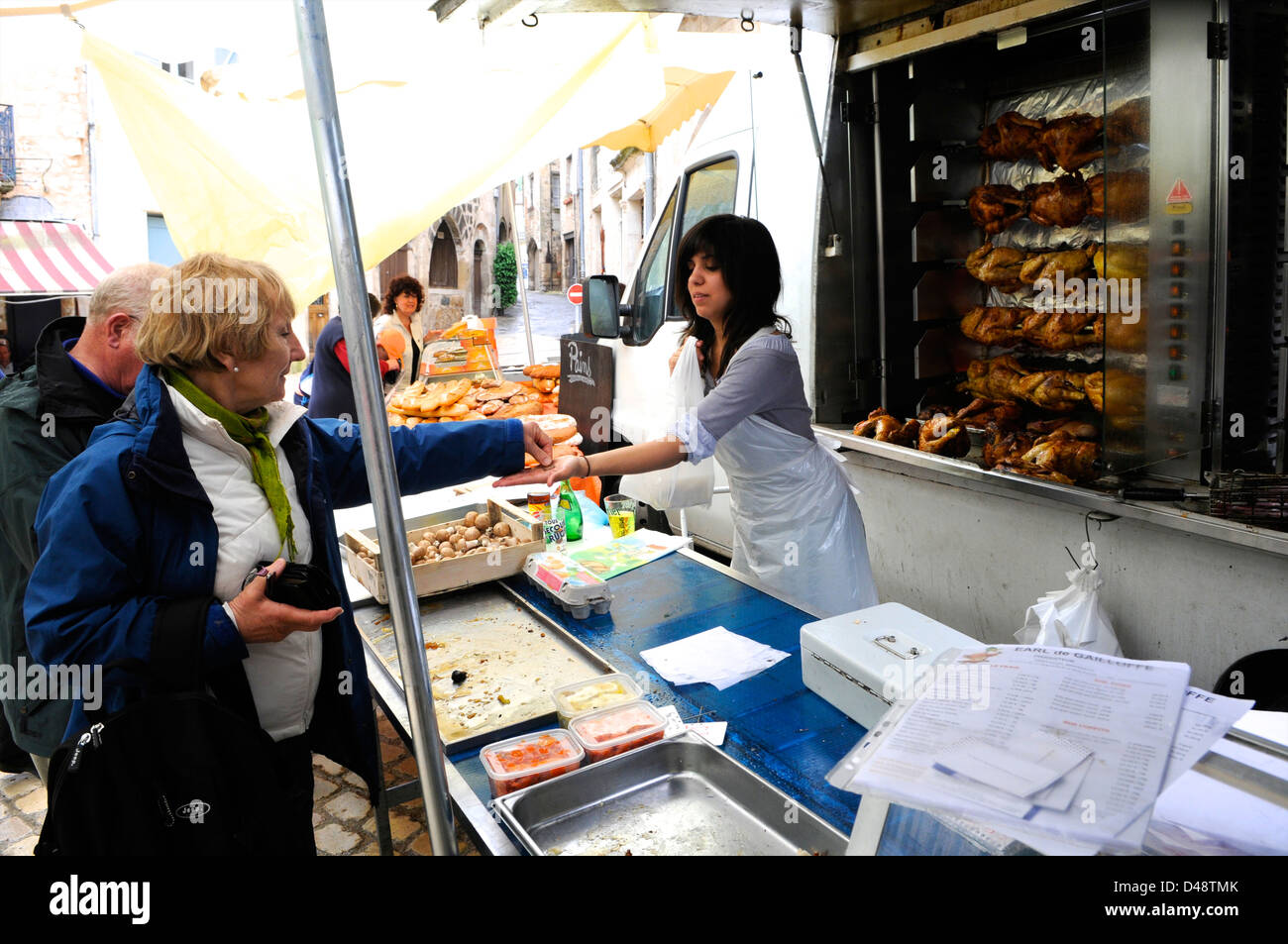 Lady selling roast chickens from her van. Saint-Antonin-Noble-Val, Tarn et Garonne, France Stock Photo