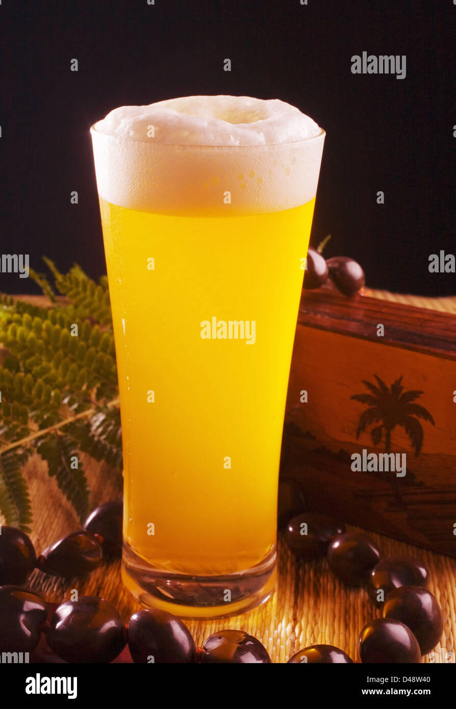 A Tall Foaming Pint Of Beer In A Tiki Bar Setting. Stock Photo