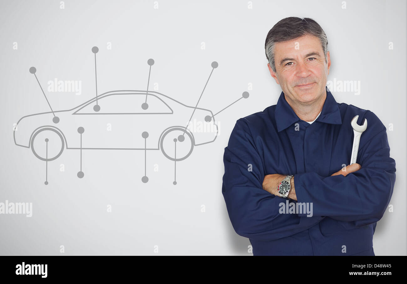 Mature mechanic standing next to car diagram Stock Photo
