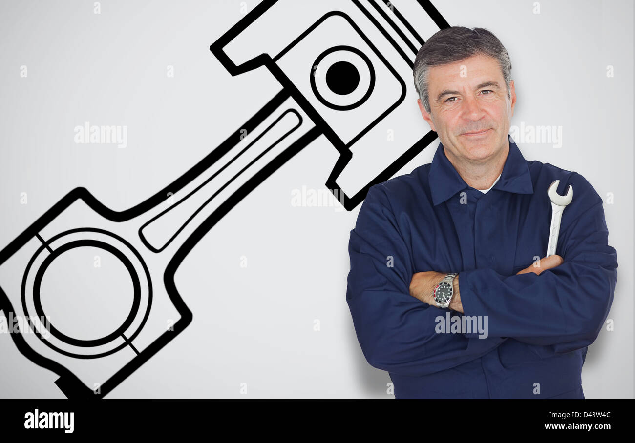 Mature mechanic standing next to car symbol Stock Photo