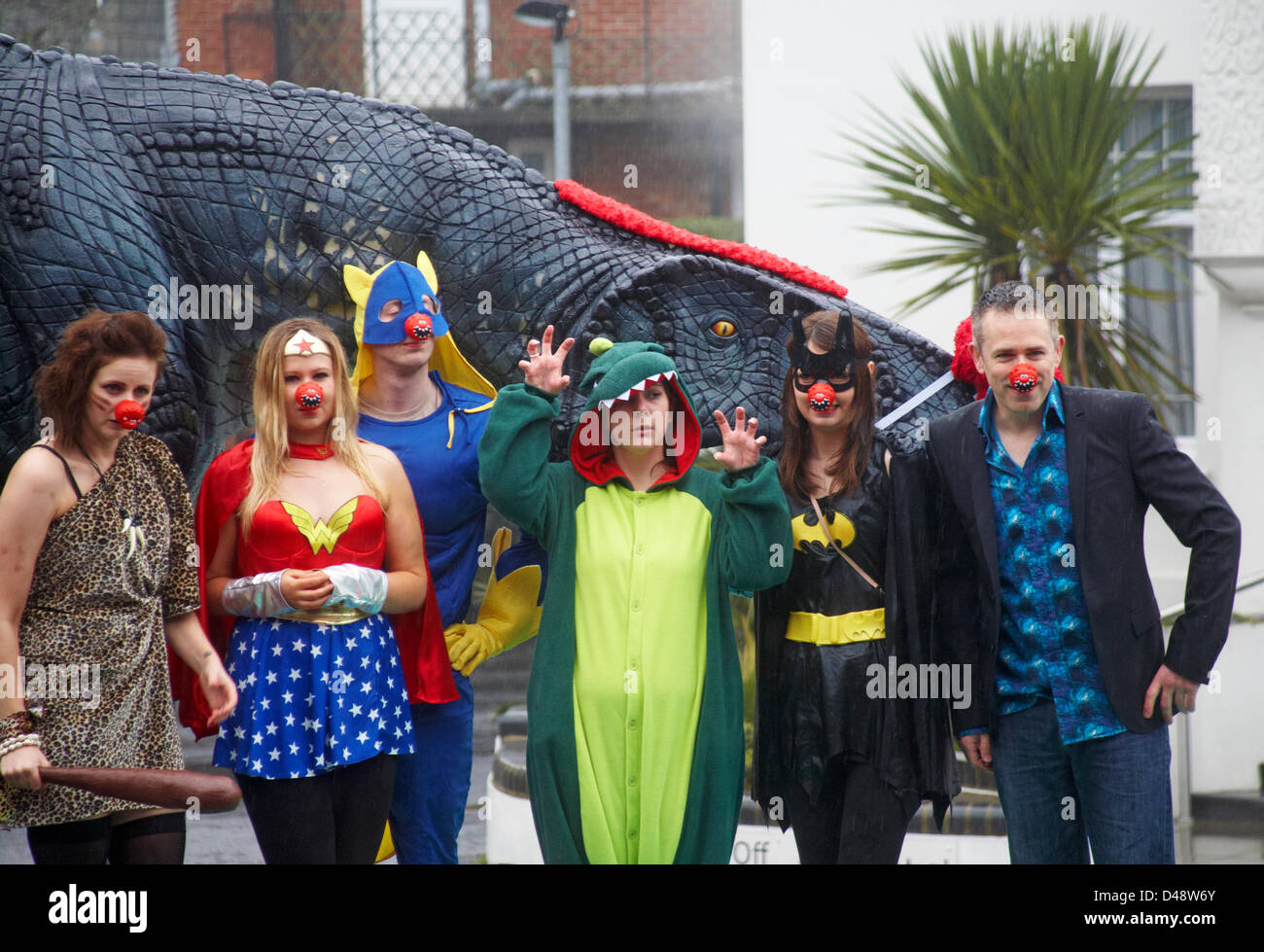 Bournemouth, UK. 8th March 2013. COMEDY Darren the dinosaur is released onto the streets of Bournemouth in aid of Comic Relief. Darren the dinosaur is three metres tall by eight metres long and was used in Walking with Dinosaurs, He was set free by celebrity Chris Jarvis from outside the BIC. The event was organised by Sainsbury's to encourage people to call into any store to get their red noses to protect themselves should they see the prehistoric creature while out and about. Credit:  Carolyn Jenkins / Alamy Live News Stock Photo