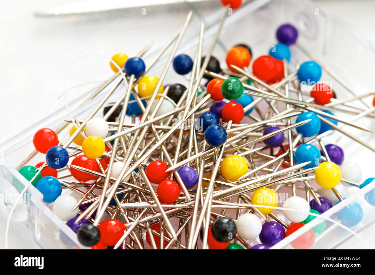 jumble of dressmaker/craft straight pins with coloured plastic heads
