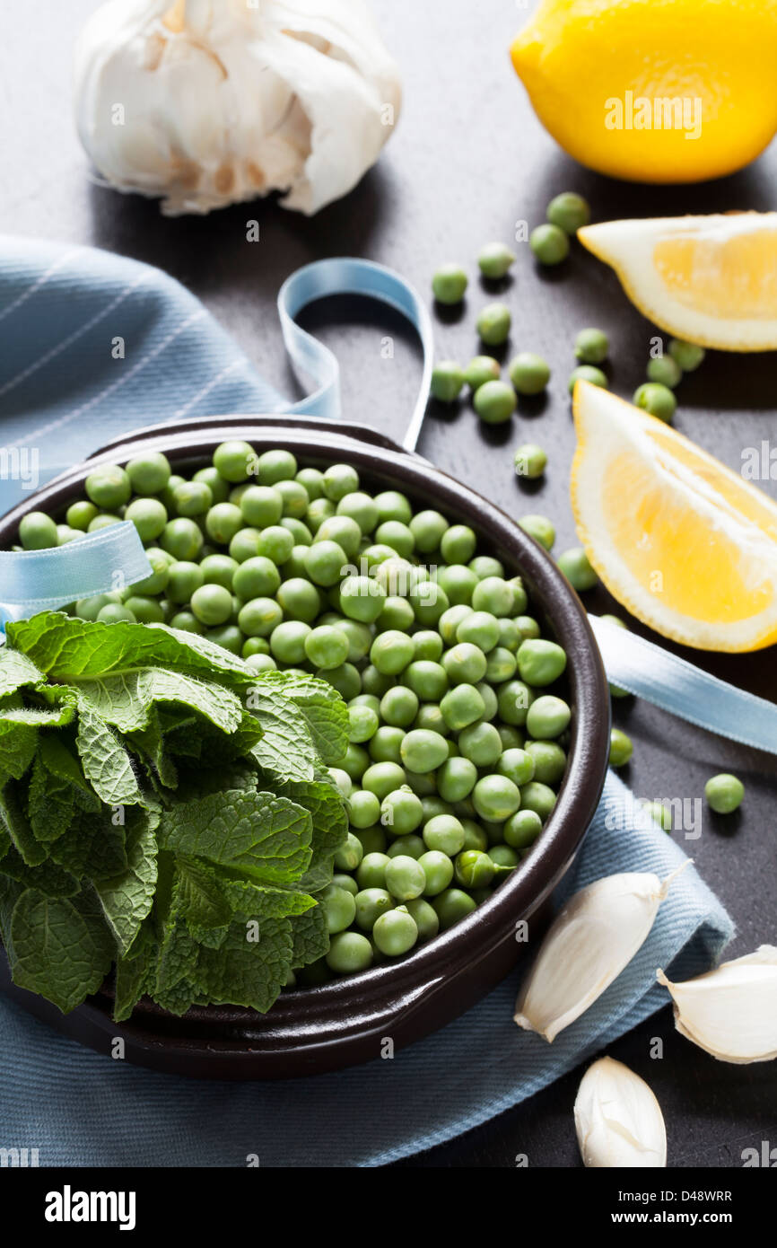 Ingredients including fresh mint leaves,, peas, lemons and garlic
