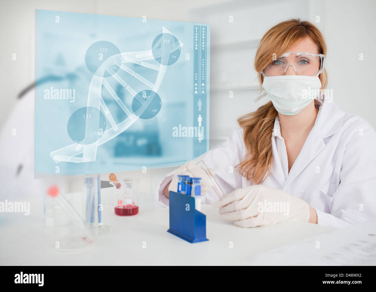 Chemist working in the lab with futuristic interface Stock Photo