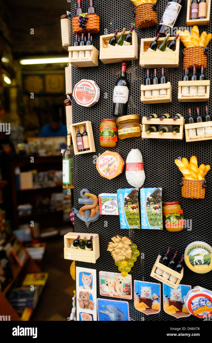 Souvenir shop selling fridge magnets that depict the French food and wine, including baguettes and cheese. Cordes, Tarn, France Stock Photo