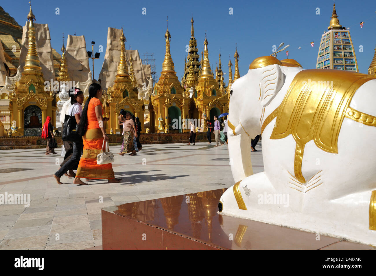 Elephant Statue and Visitors, Shwedagon Pagoda, Yangon, Myanmar Stock Photo