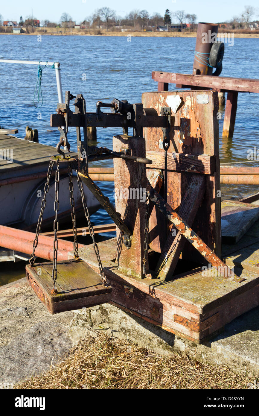 Old wooden and rusted weight in fishing harbour, Baltic sea, Poland Stock Photo