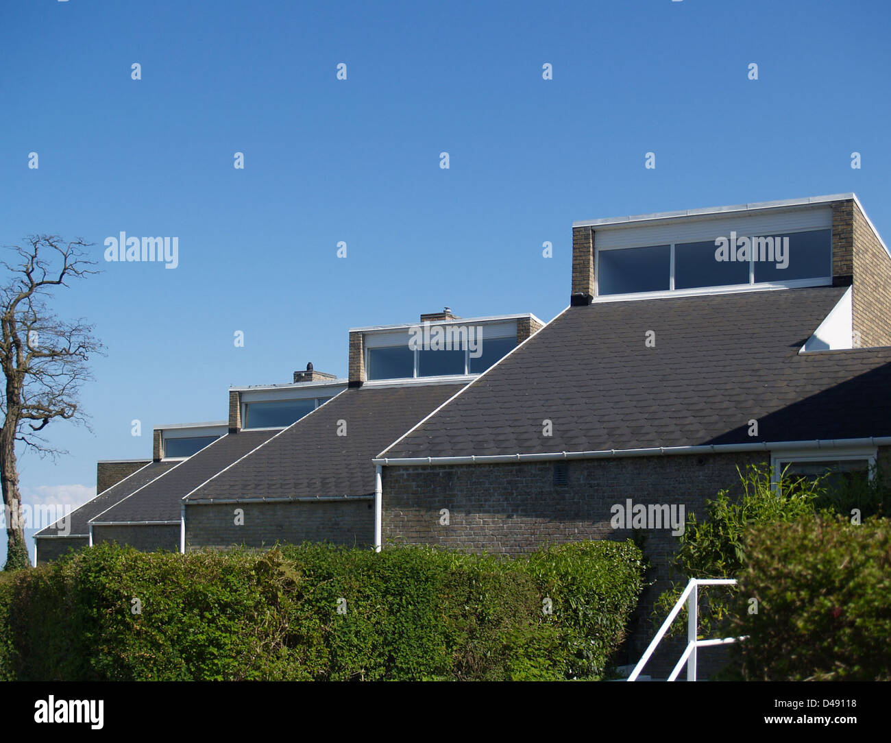 Søholm I, designed by Arne Jacobsen between 1946-1950, is a complex of modernist row houses in Copenhagen. The design reflects Jacobsen's approach to functionalism, with emphasis on minimalist aesthetics and integration with the surrounding environment. Stock Photo
