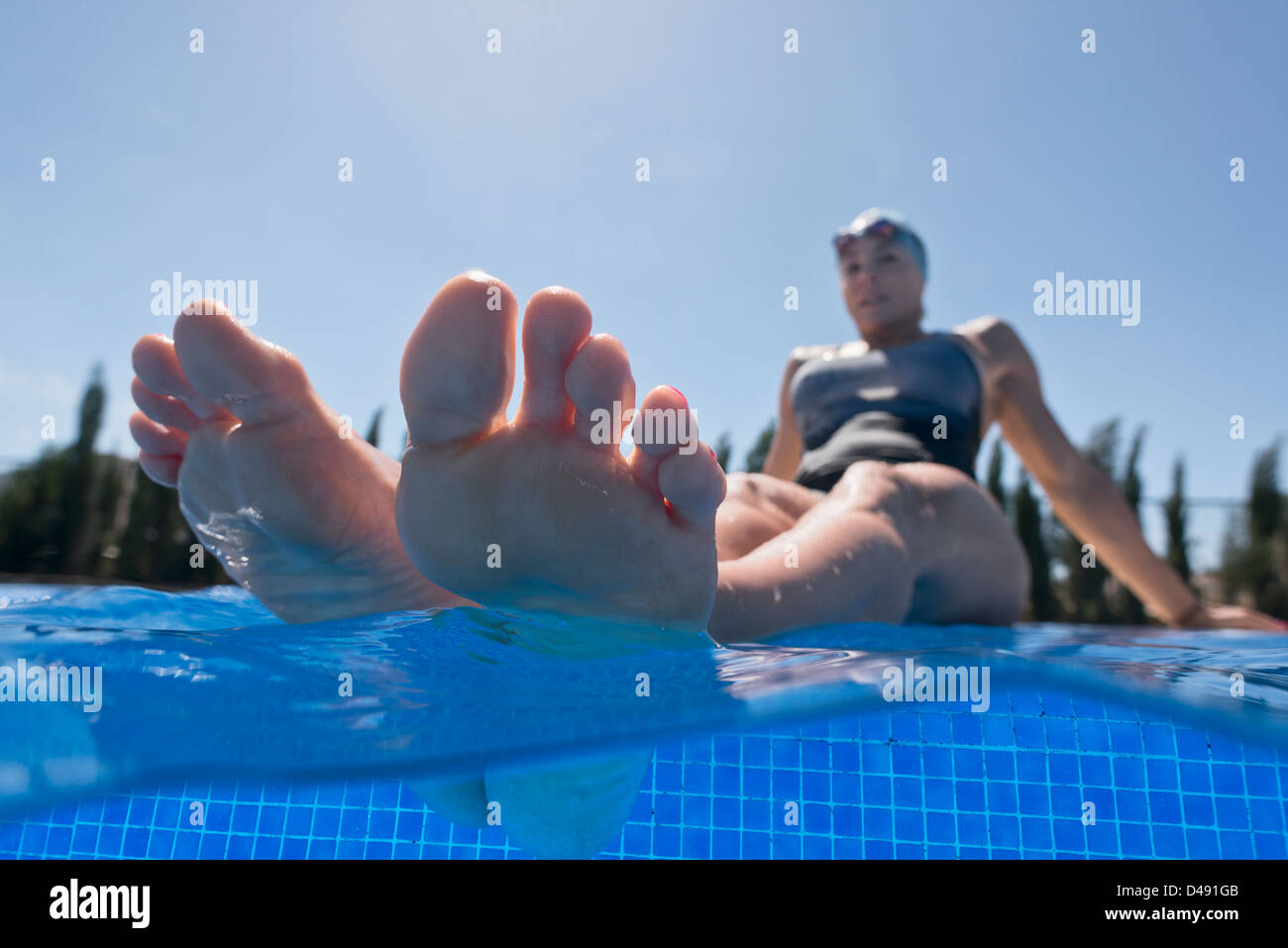 A woman soaking her feet in the swimming pool;Tarifa cadiz andalusia