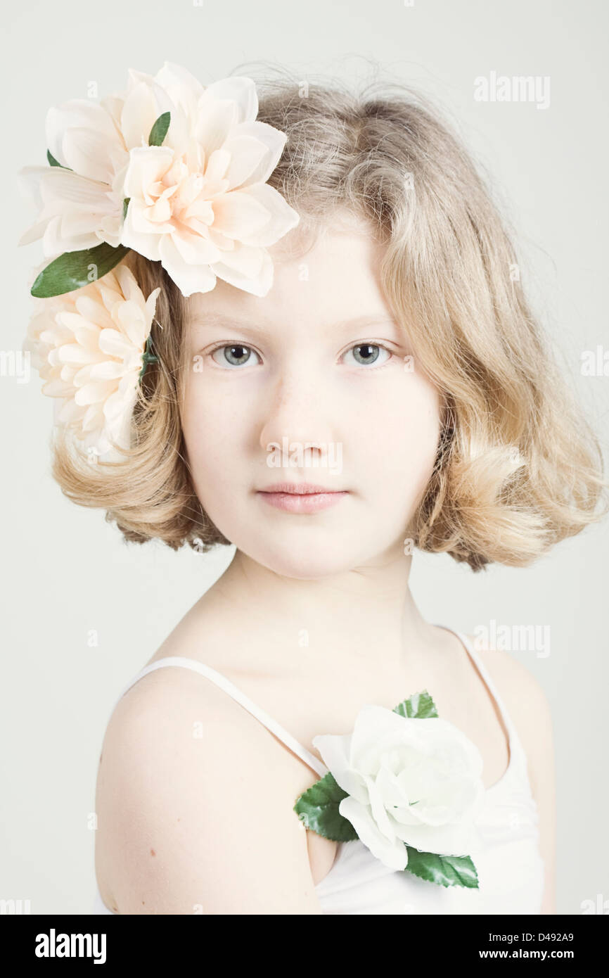 Angelic Young Blond Caucasian Girl With Pink Flowers In Her Hair