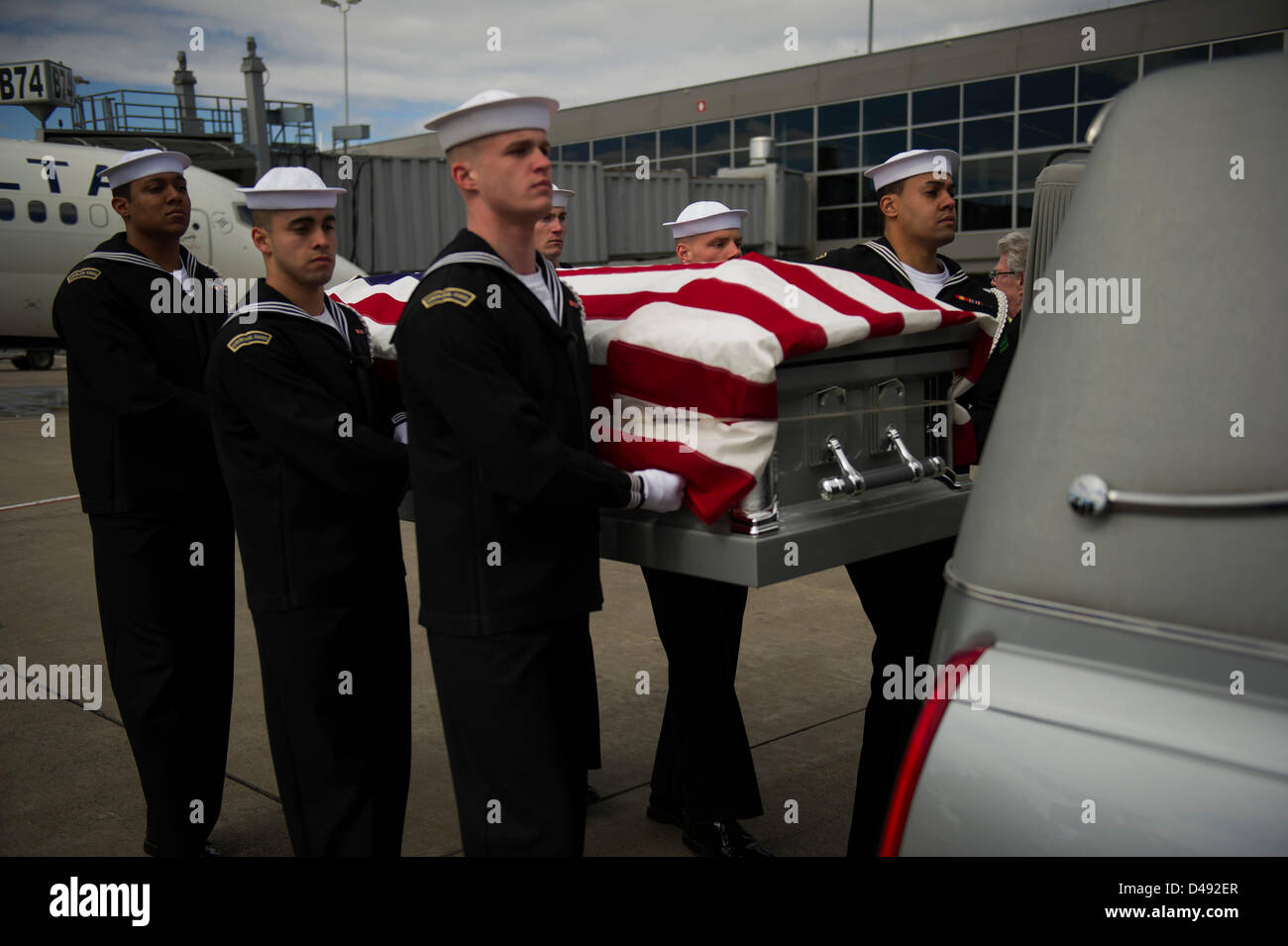 Members of the US Navy Ceremonial Guard conduct a dignified transfer of remains ceremony at Washington Dulles International Airport for one of two Sailors recovered from the Civil War ironclad USS Monitor March 6, 2013 in Sterling, Virginia. The Monitor sank off Cape Hatteras, NC in 1862. The two Sailors will be interred with full military honors at Arlington National Cemetery. Stock Photo