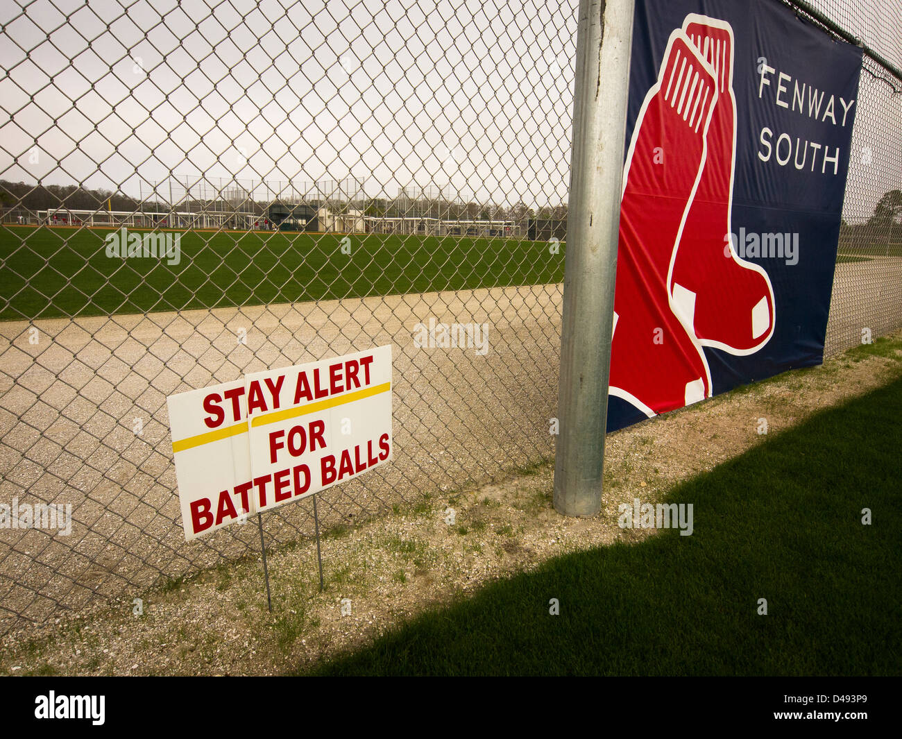 Since 1888, Boston Red Sox get ready for season opener in April in warm Florida, where a sign warns players and fans. Stock Photo