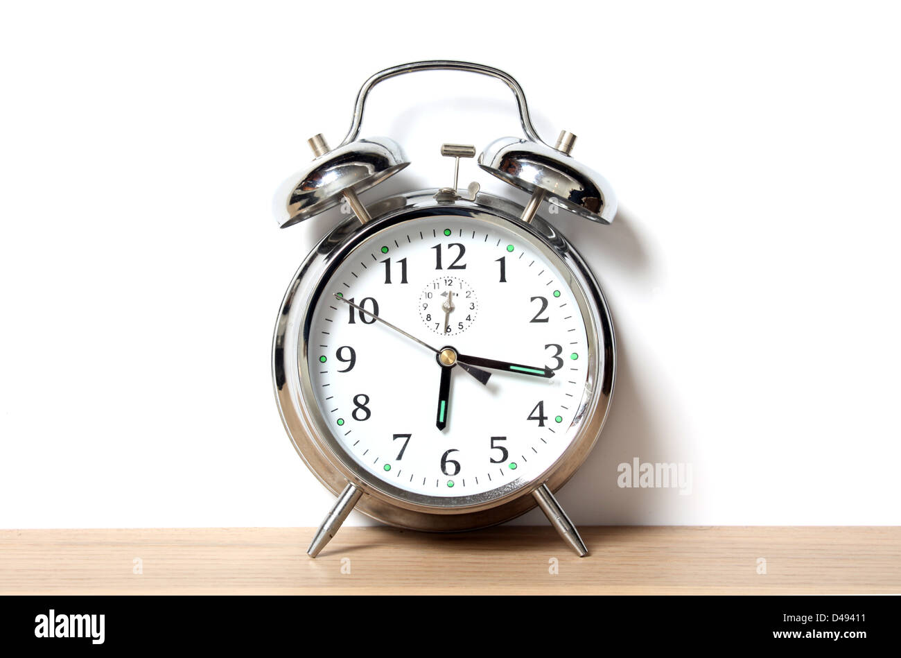 Chrome alarm clock with bells on, set just before 6-15 Stock Photo