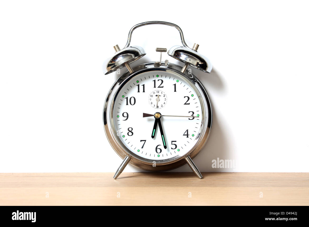 Chrome alarm clock with bells on, set just before 6-30 Stock Photo