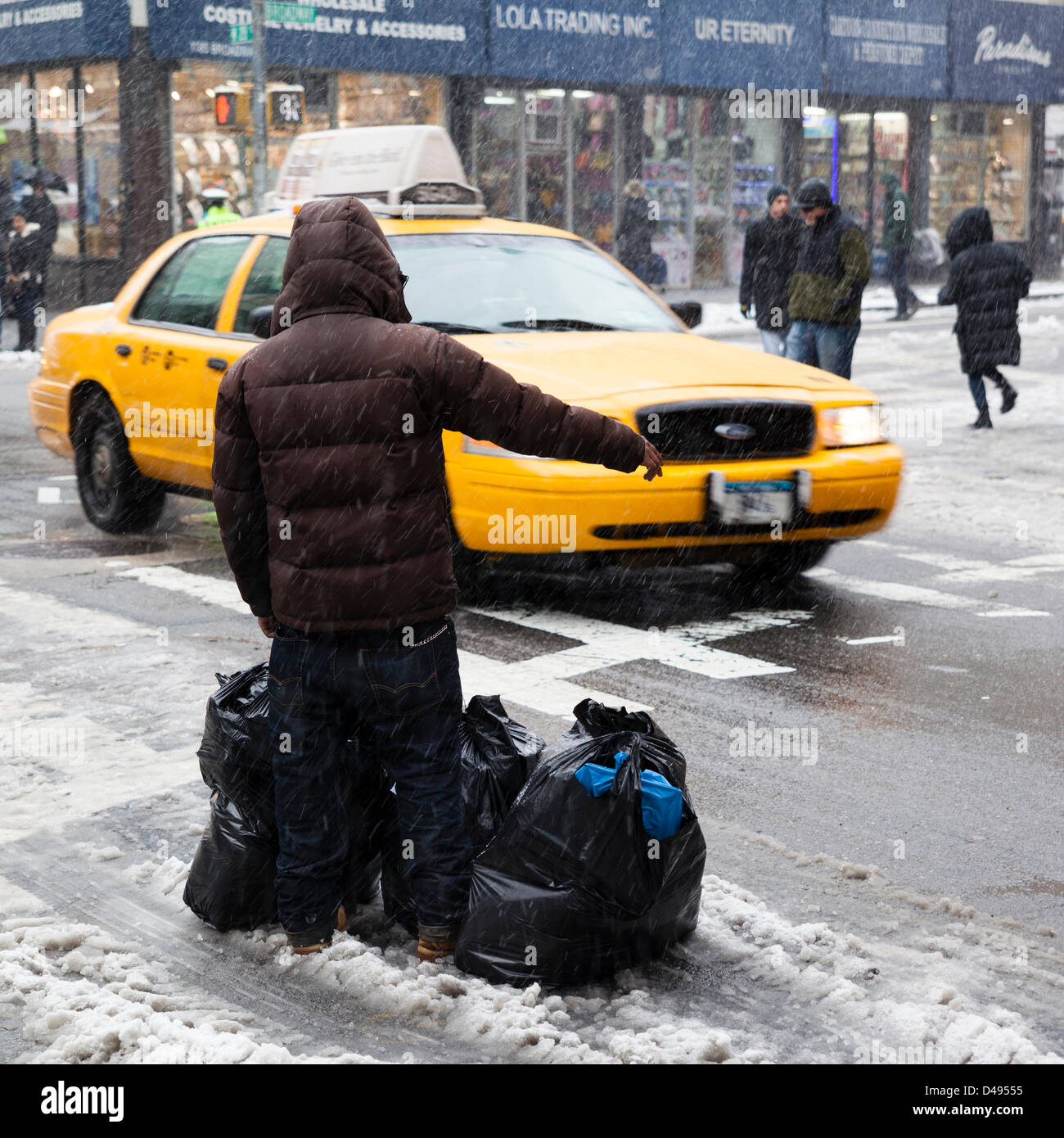 New York, USA. 8th March 2013. The strong snowstorm, day ago paralyzed a life in Washington and middle USA states, come to Manhattan today. Transportation is hard in this weather. Many yellow cab stay out of service. And catch the cab is a big problem. Credit:  Alex Potemkin / Alamy Live News Stock Photo