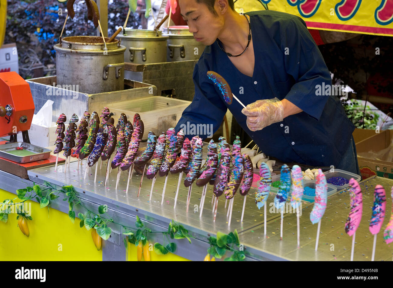 A food vendor at a festival in Japan is selling chocolate covered