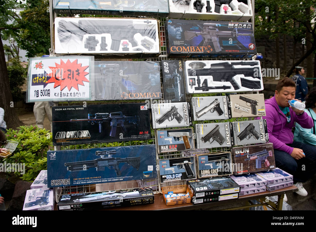 Vendor at festival in Japan selling nonfiring replica guns and air