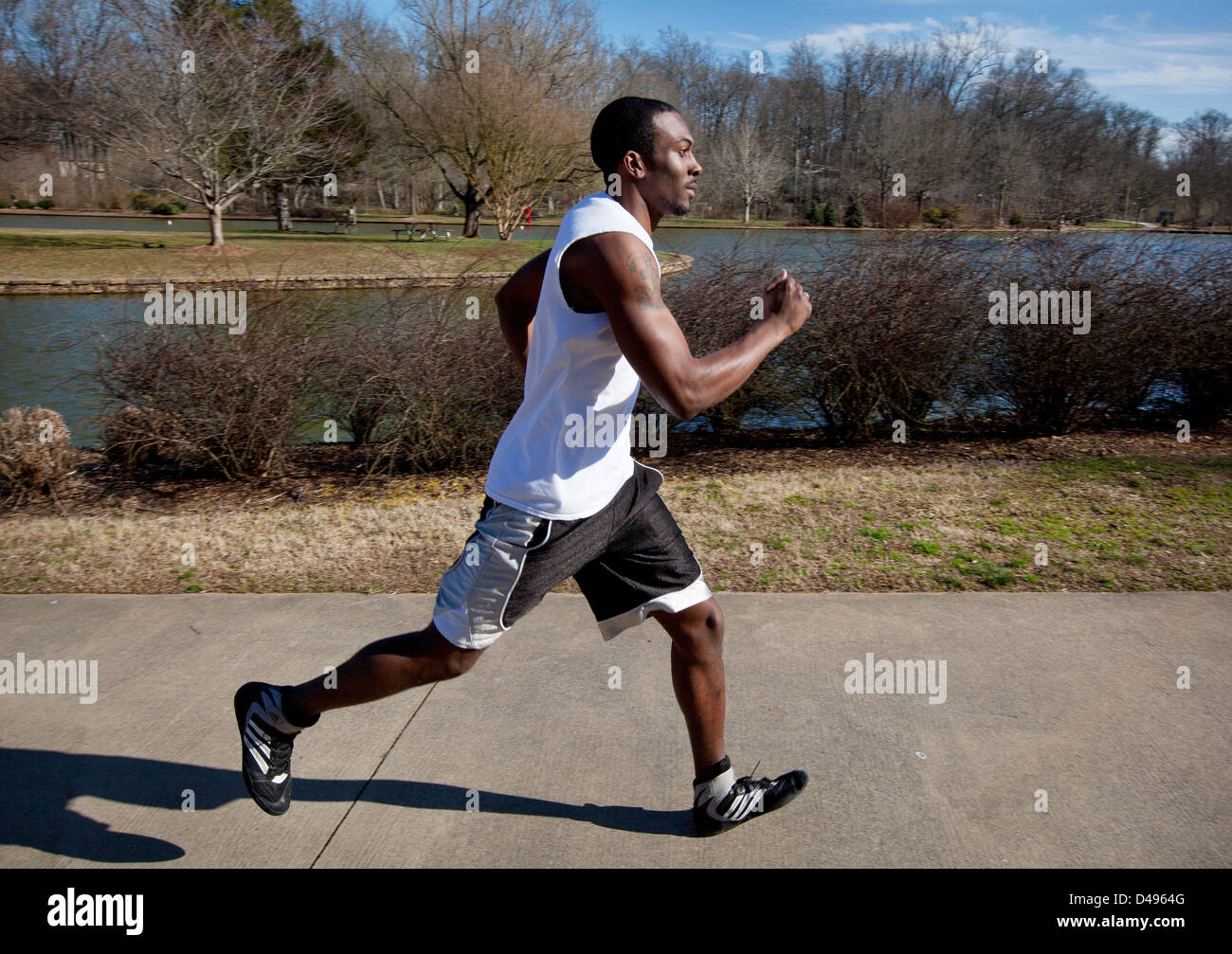 Sporty man jogging in a park stock photo