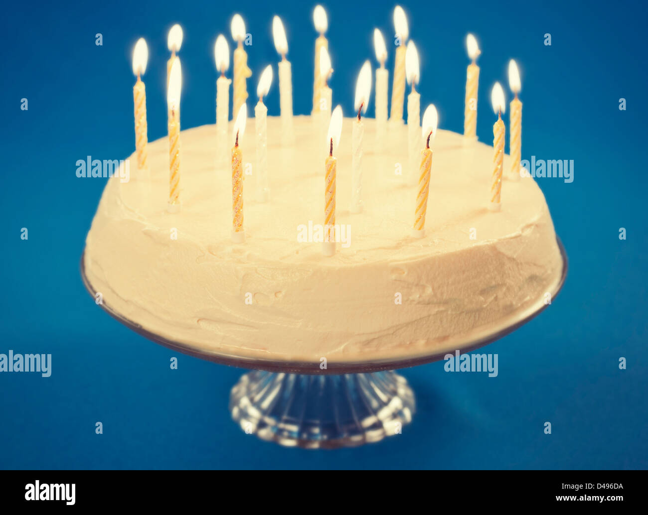 Birthday cake with candles on blue background Stock Photo - Alamy