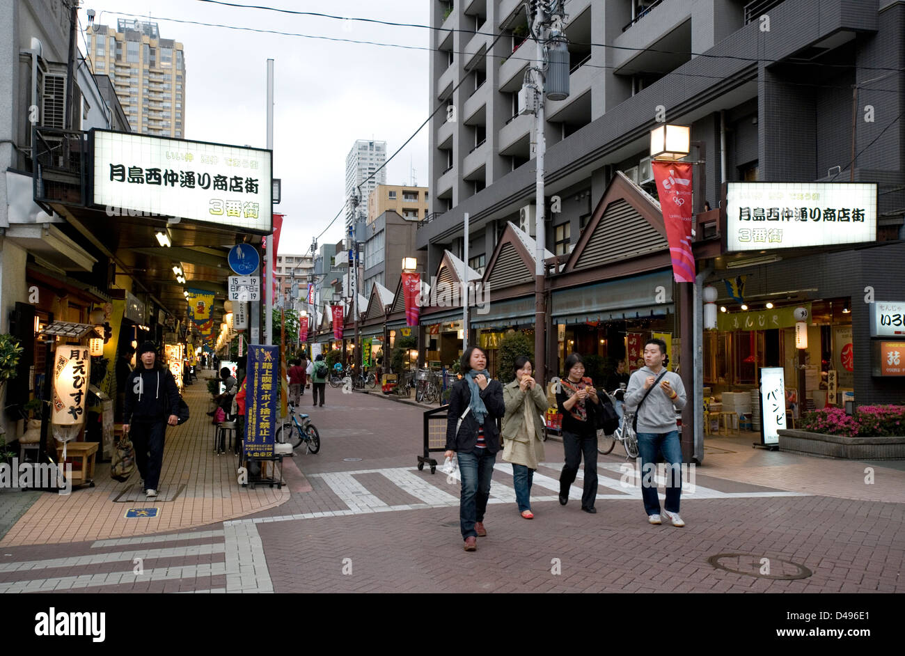 Street running through a manjayaki restaurant district, where one can enjoy Japanese okonomiyaki pizza, Tsukishima, Tokyo. Stock Photo