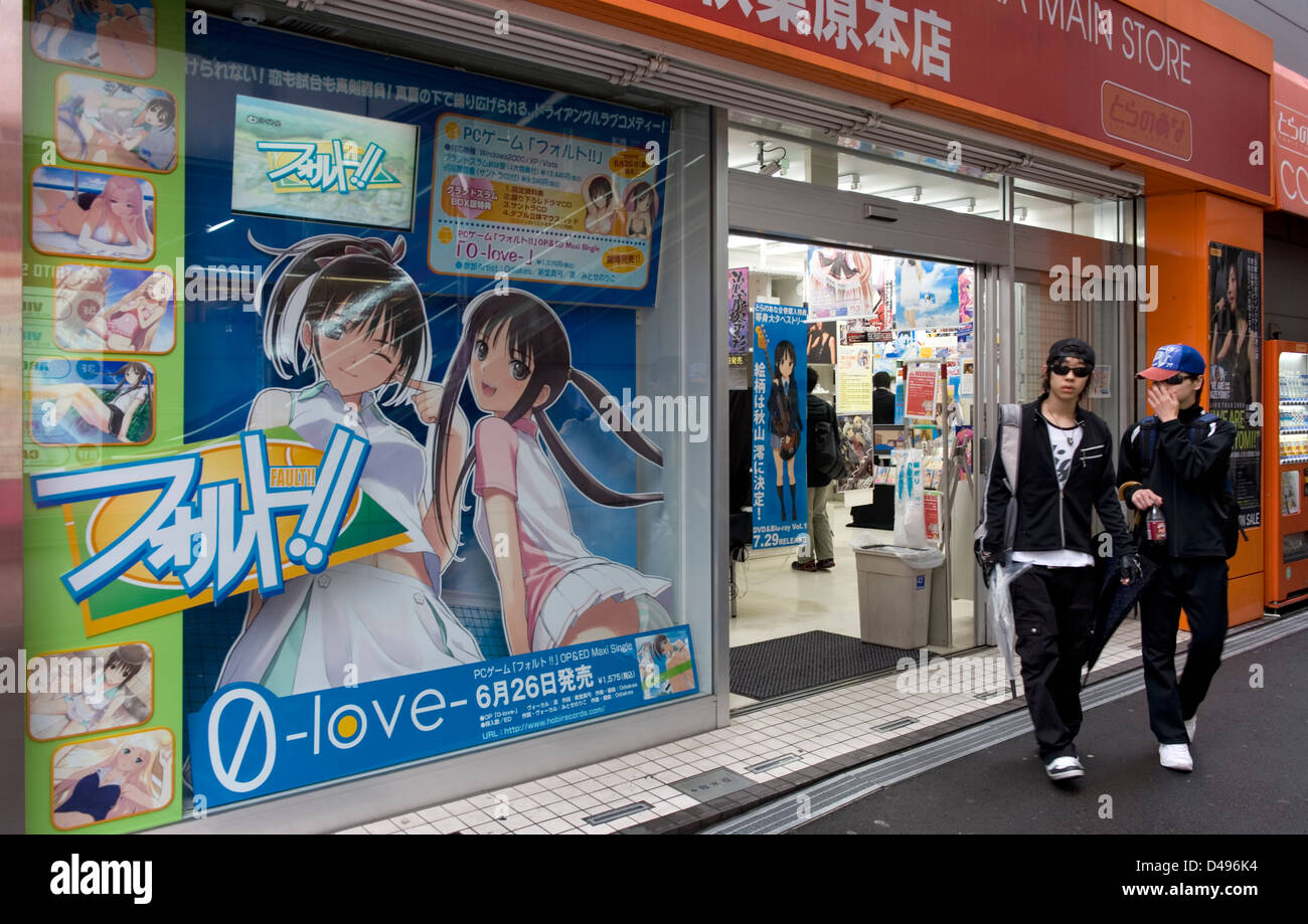 Two otaku geek teenagers coming out of Japanese anime DVD and comic book store in consumer electronics district Akihabara, Tokyo Stock Photo