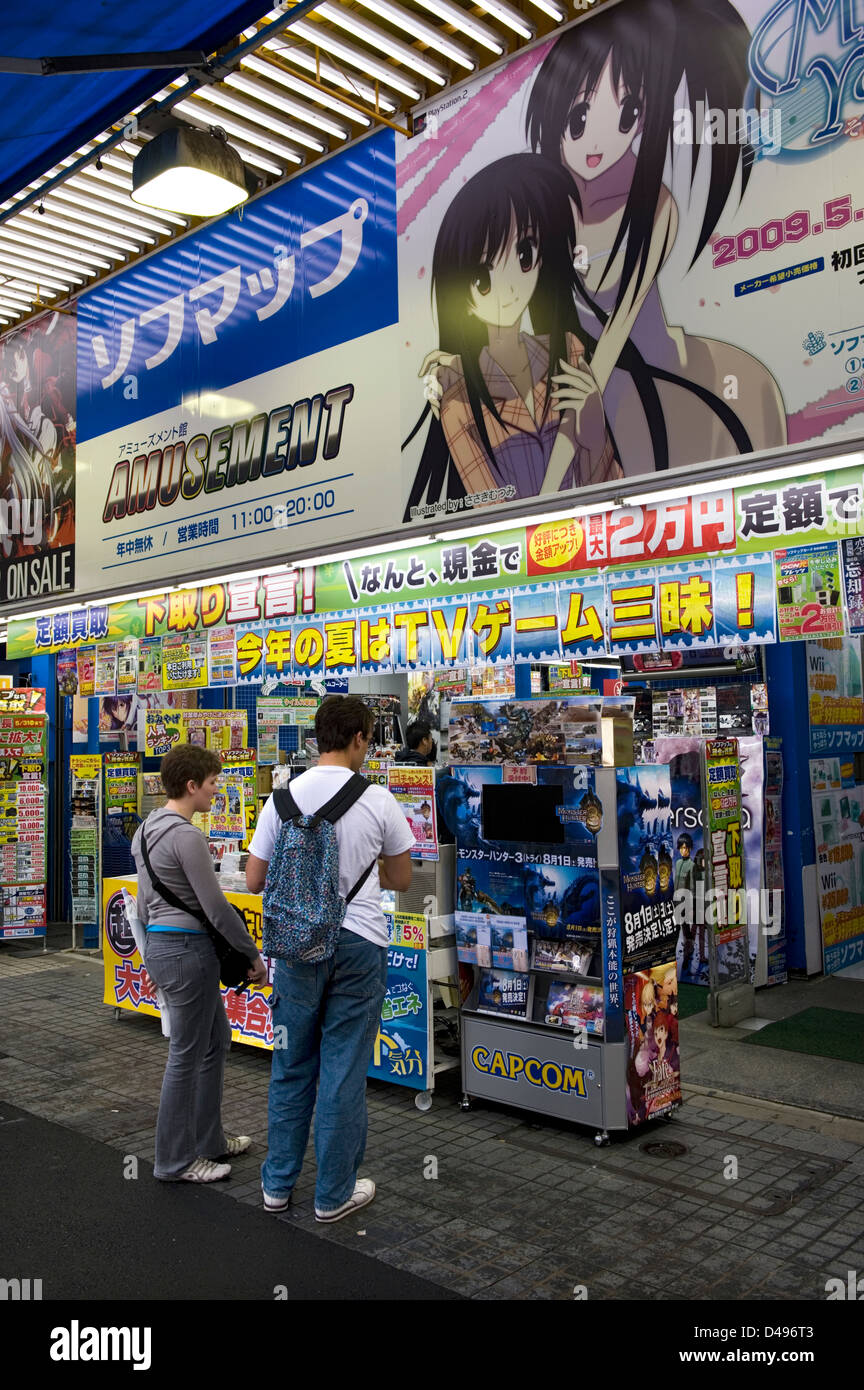 Foreign customers looking for deal at computer game and software shop in consumer electronics district of Akihabara, Tokyo Stock Photo