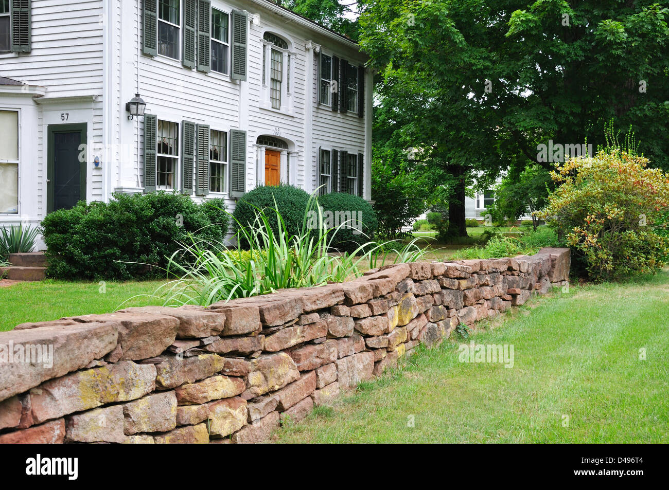 Stonewall in front yard of New England house Stock Photo - Alamy