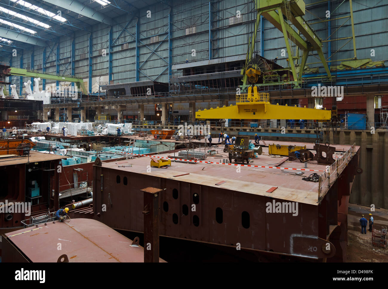 Papenburg, Germany, Meyer Werft GmbH, an employee of the Meyer shipyard in a roofed building dock Stock Photo